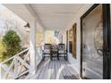 Cozy front porch with rocking chairs, lantern lighting, and decorative rustic shutters at 511 Laird Rd, Hiram, GA 30141