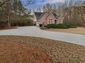 Lovely brick home featuring an attached garage and a spacious, paved driveway at 2688 Kelly Cove Dr, Buford, GA 30519