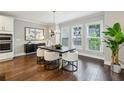 Bright dining area featuring hardwood floors, modern lighting, and large windows, perfect for Gathering meals at 1165 Millennium Park Rd, Decatur, GA 30033