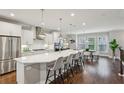 Modern kitchen with stainless steel appliances, large island, quartz countertops, and hardwood floors at 1165 Millennium Park Rd, Decatur, GA 30033