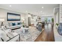 Open-concept living space with hardwood floors, stylish furniture, and a seamless flow to the kitchen at 1165 Millennium Park Rd, Decatur, GA 30033