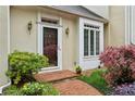 Inviting front entrance with brick walkway, well-manicured landscaping, and charming exterior lights at 12 Braemore Dr, Atlanta, GA 30328