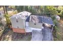 Aerial view displays the home's roof, attached carport, brick foundation, and a storage shed at 2020 Kenwood Se Pl, Smyrna, GA 30082