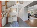 Bright foyer with staircase, console table, and views into the living room at 2049 Castleway Ne Ln, Atlanta, GA 30345
