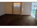 Spacious living room features neutral walls, carpeted flooring, and a large window with natural light at 3788 Travis Trce, Decatur, GA 30032