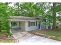 Exterior view of home with car port and painted white brick and blue door at 2270 Cresta Dr, Decatur, GA 30032