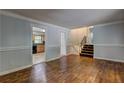 Living room featuring hardwood floors, staircase, and neutral paint, showing doorway into kitchen at 2270 Cresta Dr, Decatur, GA 30032