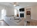 Bright living room with hardwood floors, fireplace, stylish furniture and decor, and a large window with natural light at 3323 Owl Creek Pkwy, Acworth, GA 30102