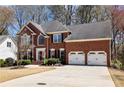 Elegant brick home with a three-car garage and well-maintained landscaping at 1180 Mayfield Manor Dr, Alpharetta, GA 30009