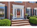 Inviting front entrance with a decorative glass door and manicured landscaping at 1180 Mayfield Manor Dr, Alpharetta, GA 30009