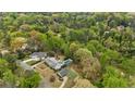 Aerial view of a home with pool nestled in a wooded area at 1724 Ridge Valley Nw Ct, Atlanta, GA 30327