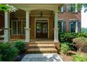 Inviting front entrance with brick steps, stately columns, and a double door entry at 981 Cranbrook Glen Ln, Snellville, GA 30078