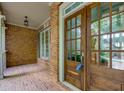 Charming front porch with brick flooring and a beautiful wood front door with glass panes at 981 Cranbrook Glen Ln, Snellville, GA 30078