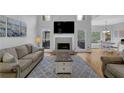 Bright living room with a fireplace, large windows, and a cozy seating area at 5355 Avonshire Ln, Cumming, GA 30040