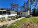 Beautiful front yard with landscaping and a well-lit walkway to the front porch at 621 Hood Rd, Stockbridge, GA 30281