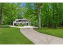Traditional two-story brick house on a large lot with a circular driveway and mature landscaping at 950 Ivy St, Cumming, GA 30041
