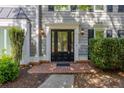 Elegant front door with sidelights, decorative trim, and a brick walkway, adding curb appeal at 3107 Sandhurst Dr, Woodstock, GA 30189