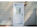 White back door with glass insert, located at the rear of the home, illuminated by an exterior light at 3465 Maple Valley Dr, Cumming, GA 30040