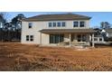 Rear view of a two-story home with a covered patio and large windows, set on a spacious lot at 456 Maypop Ln, Woodstock, GA 30188