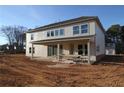 Two-story house featuring a covered patio and many large windows on a spacious lot at 456 Maypop Ln, Woodstock, GA 30188