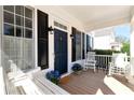 Welcoming covered front porch with rocking chairs, a swing and blue hydrangeas for a cozy feel at 6335 Hampton Creek Dr, Cumming, GA 30041
