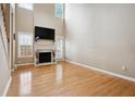 Spacious living room featuring fireplace, high ceilings, and hardwood floors at 810 Abbotts Mill Ct # 83, Duluth, GA 30097