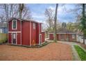 Spacious backyard with a two-story barn-like structure and a charming walkway to the main house at 875 White Sw St, Atlanta, GA 30310