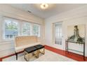 Bright sunroom features three large windows, a comfortable bench, and stylish decor at 875 White Sw St, Atlanta, GA 30310