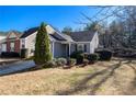 Charming home featuring a well-manicured lawn and inviting curb appeal under a clear blue sky at 1025 Lakeside Circle, Covington, GA 30016