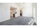 Sunlit, carpeted living room, adjacent to a modern kitchen, creating an open and inviting space at 1025 Lakeside Circle, Covington, GA 30016