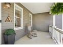 Inviting front porch with rocking chair, hanging plants, and charming decorative details at 235 Chicopee Ne Dr, Marietta, GA 30060