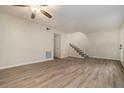 Well lit living room showcasing light colored hardwood floors and a stairway in the background at 6354 Shannon Pkwy # 15D, Union City, GA 30291