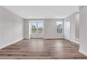 Open living area features hardwood floors, natural light, and neutral paint at , Lawrenceville, GA 30046