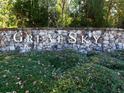 Stone wall and shrubbery marking the entrance to Great Sky community at 2055 Ripple Park Bend, Canton, GA 30114