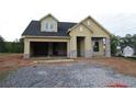 New construction home with a two-car garage, stone accents, and a welcoming front porch at 2055 Ripple Park Bend, Canton, GA 30114