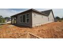 Side view of a house with stone foundation and large windows at 2055 Ripple Park Bend, Canton, GA 30114