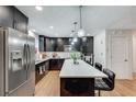 Contemporary kitchen boasts stainless steel appliances and a stylish island with bar seating at 2970 Oxford Rd, Atlanta, GA 30349