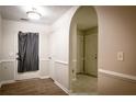Bright entryway with wood and tile flooring, neutral paint, and an arched doorway at 3013 Rockview Dr, Loganville, GA 30052