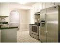 Kitchen featuring stainless steel appliances, black counters, and white cabinets with tiled backsplash at 3013 Rockview Dr, Loganville, GA 30052