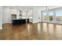 Bright, open kitchen features a large island, stainless appliances, and an abundance of white cabinetry at 630 Silva St, Cumming, GA 30040