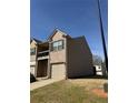 Side view of a two-story townhome featuring brick and vinyl siding at 1831 Broad River Rd, Atlanta, GA 30349