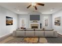 Bright living room with fireplace, ceiling fan, and neutral decor at 1831 Broad River Rd, Atlanta, GA 30349