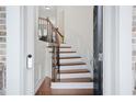 Entryway with a dark door, curved staircase and wrought iron details, leading to the upper levels at 2517 Ashwicke Se Dr, Atlanta, GA 30339