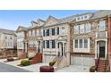 Townhome exterior with a mix of brick and stone, creating an inviting and stylish facade at 2517 Ashwicke Se Dr, Atlanta, GA 30339