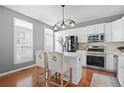 Well-lit kitchen with white cabinets, modern appliances, and a center island with seating for two at 2517 Ashwicke Se Dr, Atlanta, GA 30339
