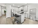 Modern kitchen with granite countertops, stainless steel appliances, and barstool seating at 7005 Livia Pt, Riverdale, GA 30296