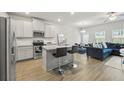Modern kitchen with granite countertops, stainless steel appliances, and adjacent living area at 7005 Livia Pt, Riverdale, GA 30296