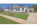 Exterior view of a white brick home, showcasing manicured landscaping and an attached garage at 123 Candler Loop, Acworth, GA 30101