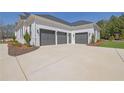 Attached three car garage with stylish dark garage doors and a concrete driveway at 123 Candler Loop, Acworth, GA 30101