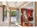Inviting foyer with hardwood floors and a view into the red living room at 1566 Arden Sw Dr, Marietta, GA 30008